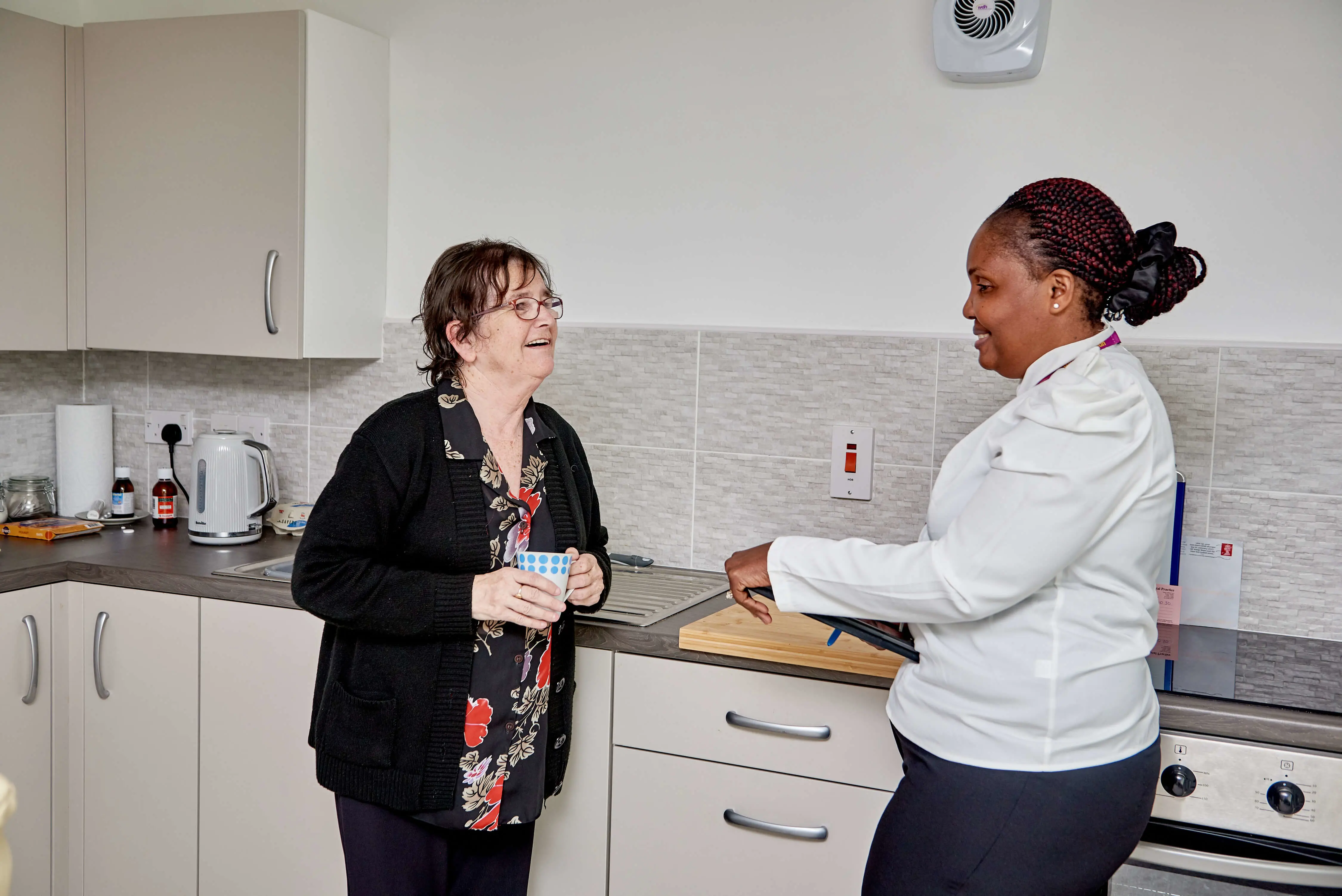 One of our employees speaking to one of our tenants in their kitchen.