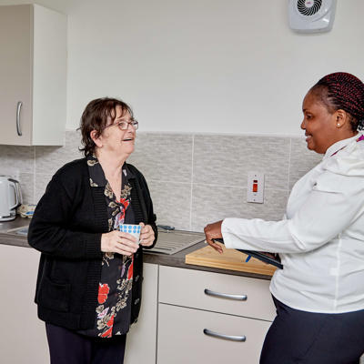 One of our employees speaking to one of our tenants in their kitchen.