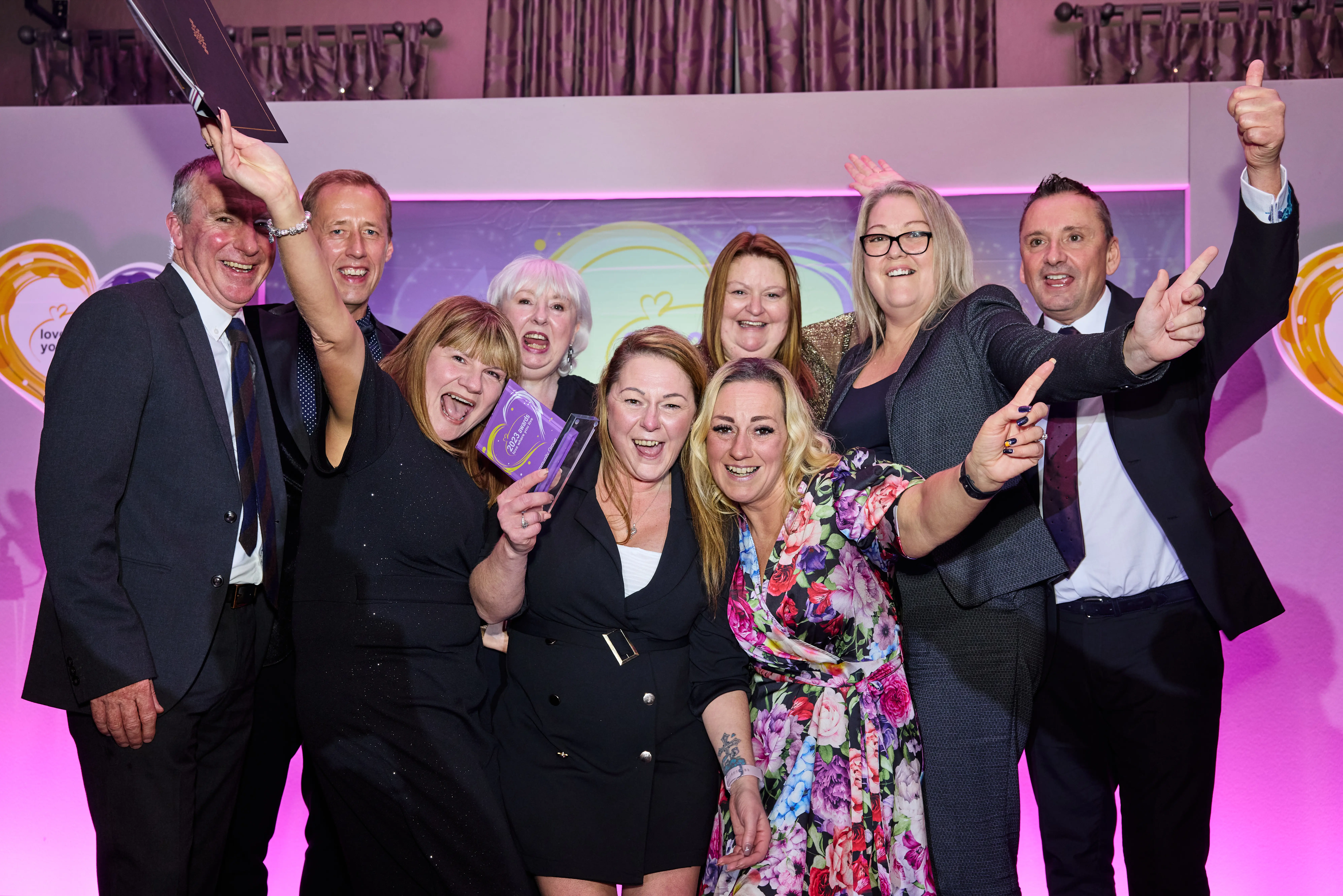 Image of a group cheering at last years LWYL awards with our Chief Executive and Deputy Chief Executive.