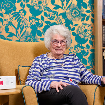 Care Link customer wearing pendant around their neck and smiling directly at camera