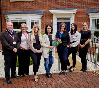 Employees with Sue Young (Executive Director of Investment) celebrating reaching a new milestone of building 4000 new homes since 2005.