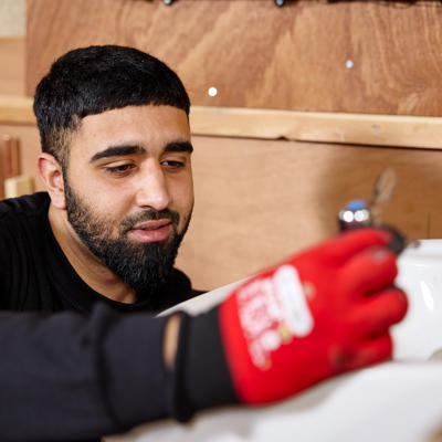 Image of one of our apprentices near a sink.