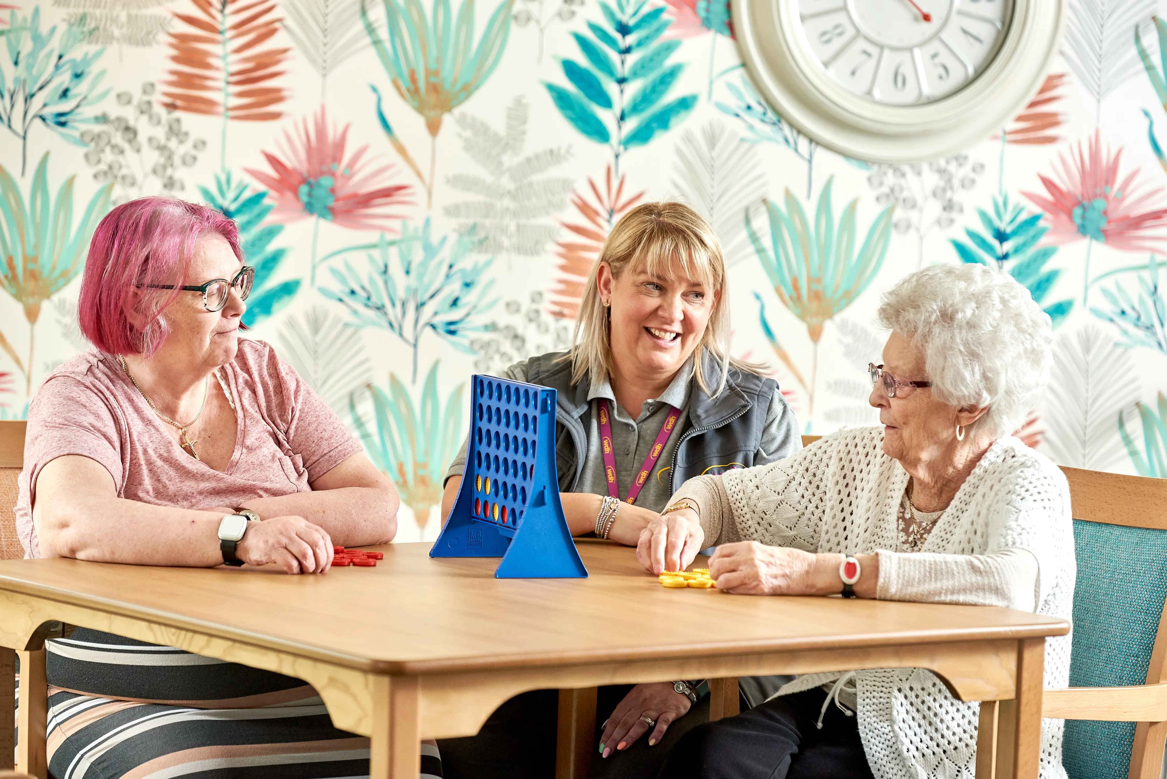 Image of tenants playing connect 4 at one of our independent living properties.