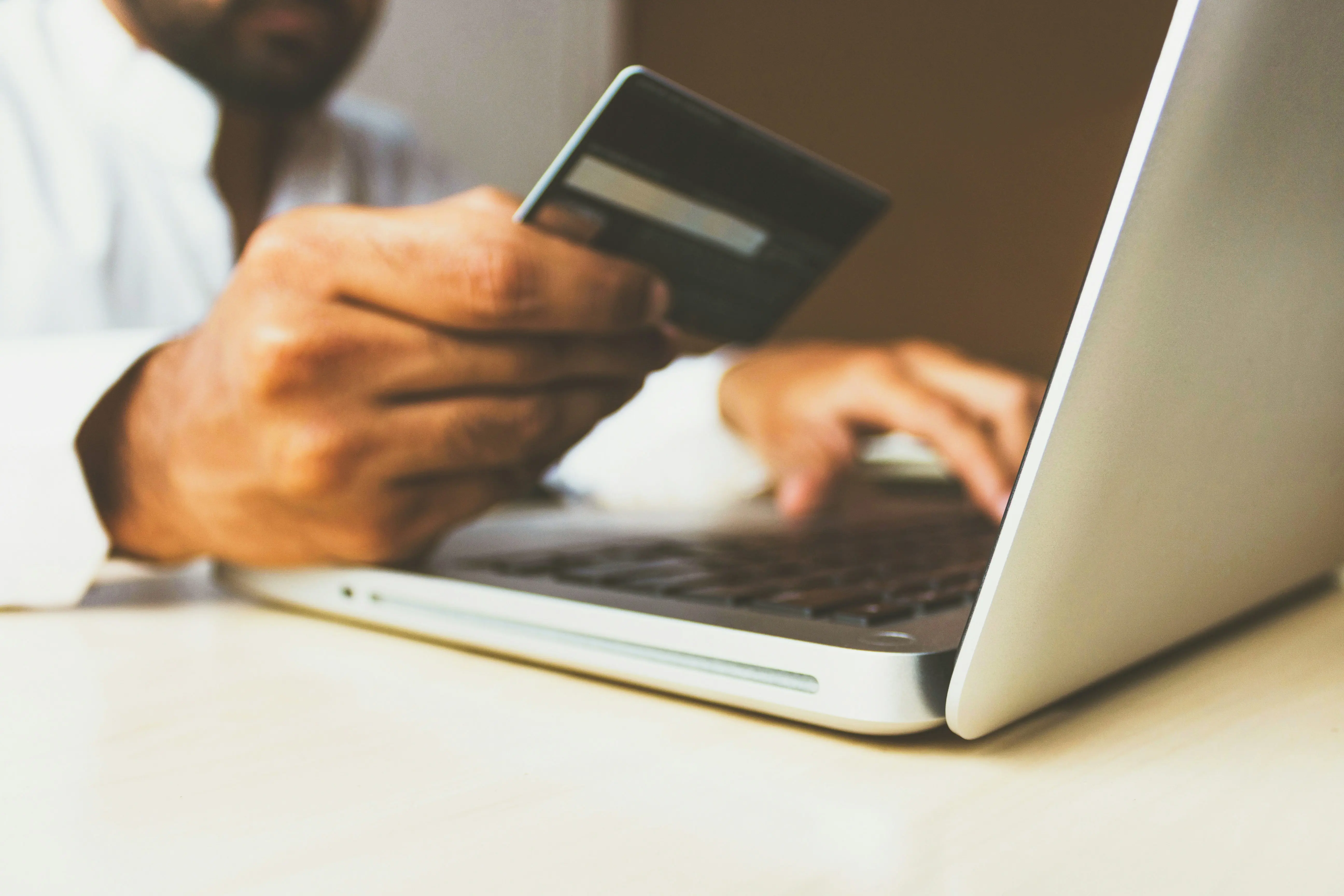 Image of someone holding a bank card.