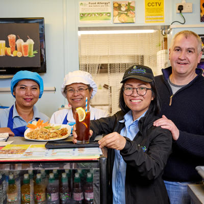 Business owners stood in their shop rented from our Commercial team.