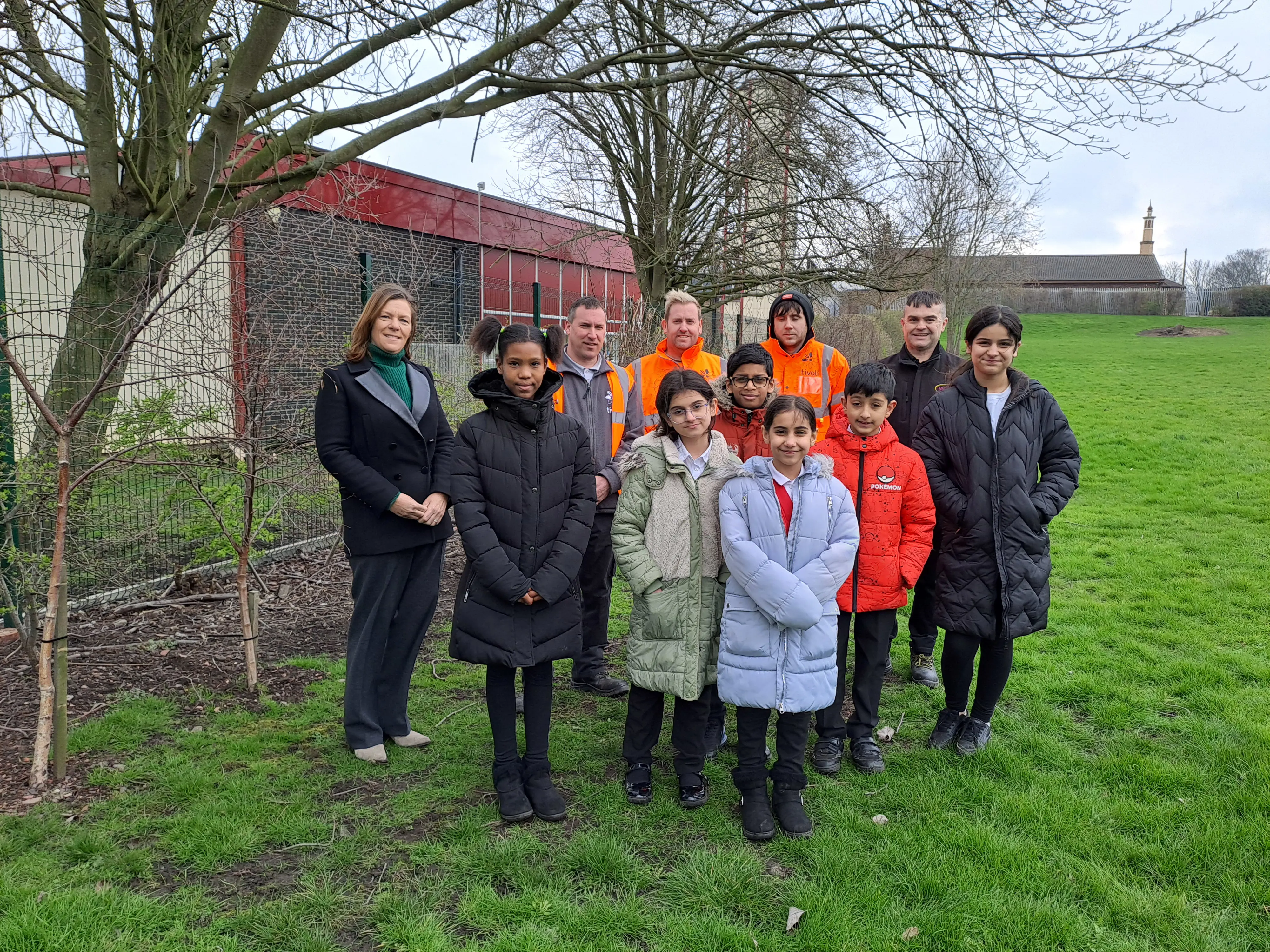 Sue Young (Executive Director of Investment) with the some of the children from St Mary's School overseeing the 38 trees planted by us.