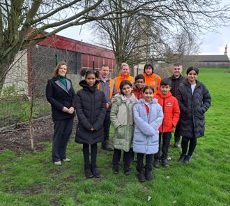 Sue Young (Executive Director of Investment) with the some of the children from St Mary's School overseeing the 38 trees planted by us.