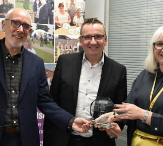 Pictured (L-R) Andrew McConnell OBE, WDH Board Chair; Andy Wallhead, WDH Chief Executive; and Julie Butterworth CMICS, Tpas Head of Consultancy with our award.