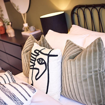 Image of a bed and bedside cabinet.