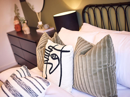 Image of a bed and bedside cabinet.
